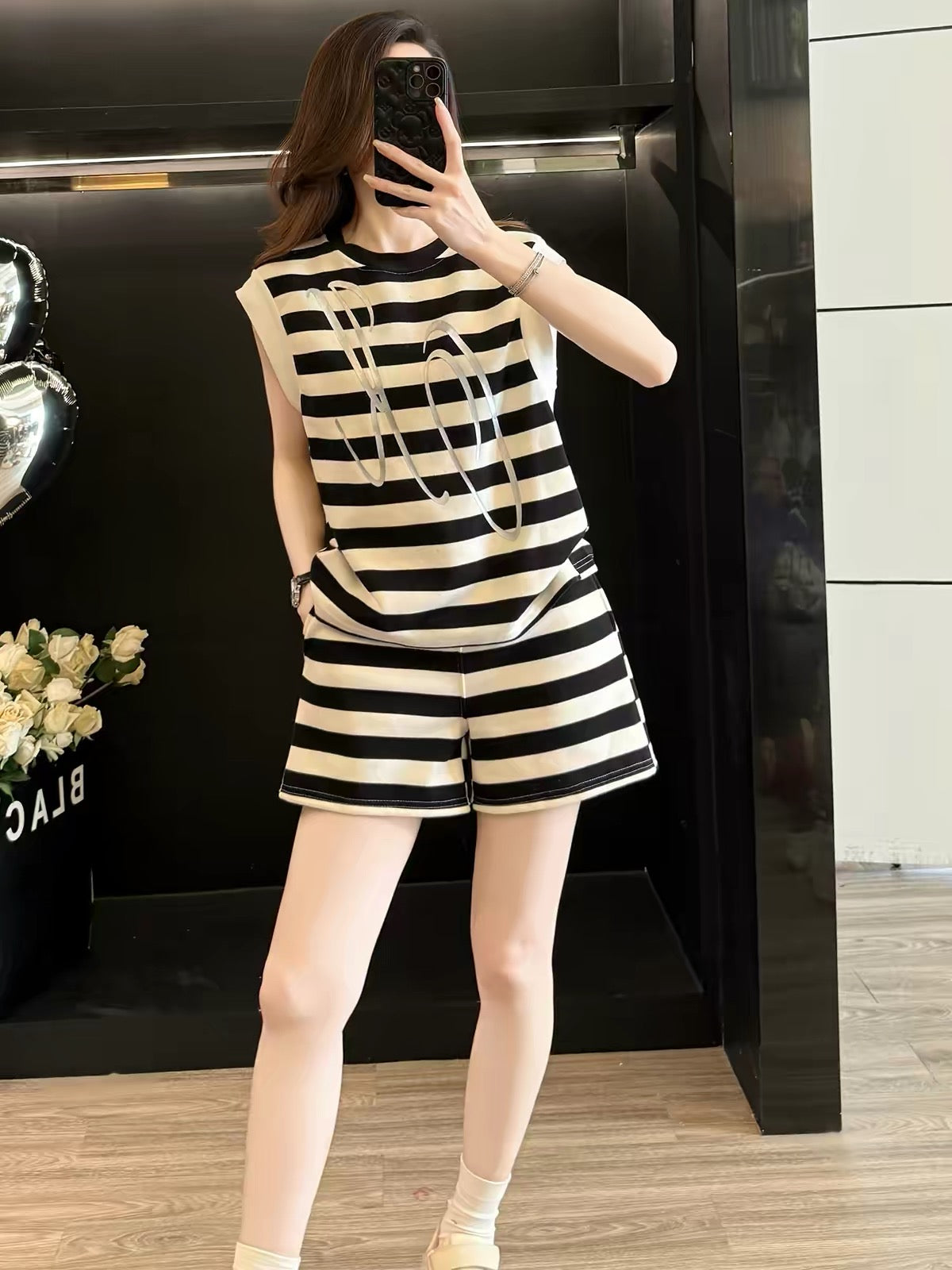 Stylish Korean-style women's summer two-piece athletic set featuring a sleeveless top and high-waisted shorts with black stripes—perfect for casual wear or running.