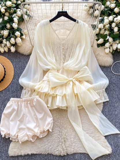 A fairy-tale style, unique design featuring a bow tie, cinched waist, lace trim, long sleeves, ruffles, and mesh. Shorts are also available.