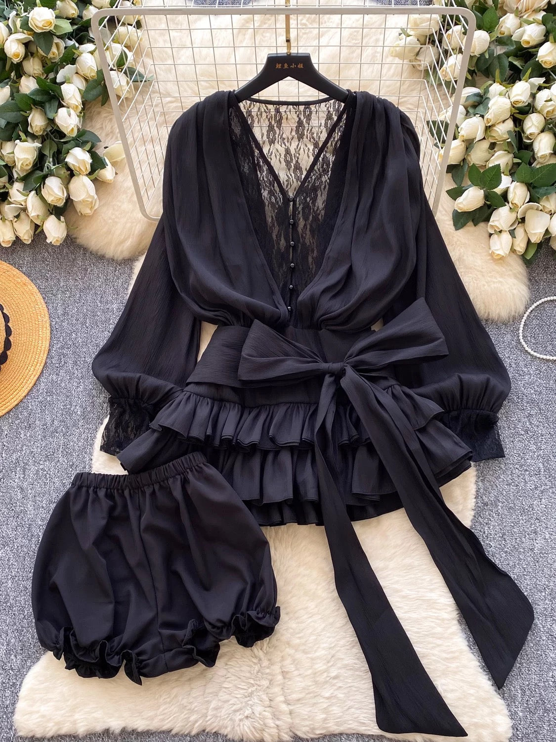 A fairy-tale style, unique design featuring a bow tie, cinched waist, lace trim, long sleeves, ruffles, and mesh. Shorts are also available.