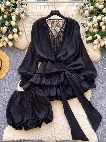 A fairy-tale style, unique design featuring a bow tie, cinched waist, lace trim, long sleeves, ruffles, and mesh. Shorts are also available.