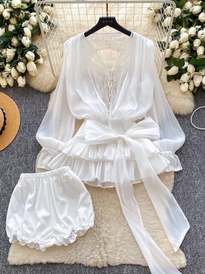 A fairy-tale style, unique design featuring a bow tie, cinched waist, lace trim, long sleeves, ruffles, and mesh. Shorts are also available.