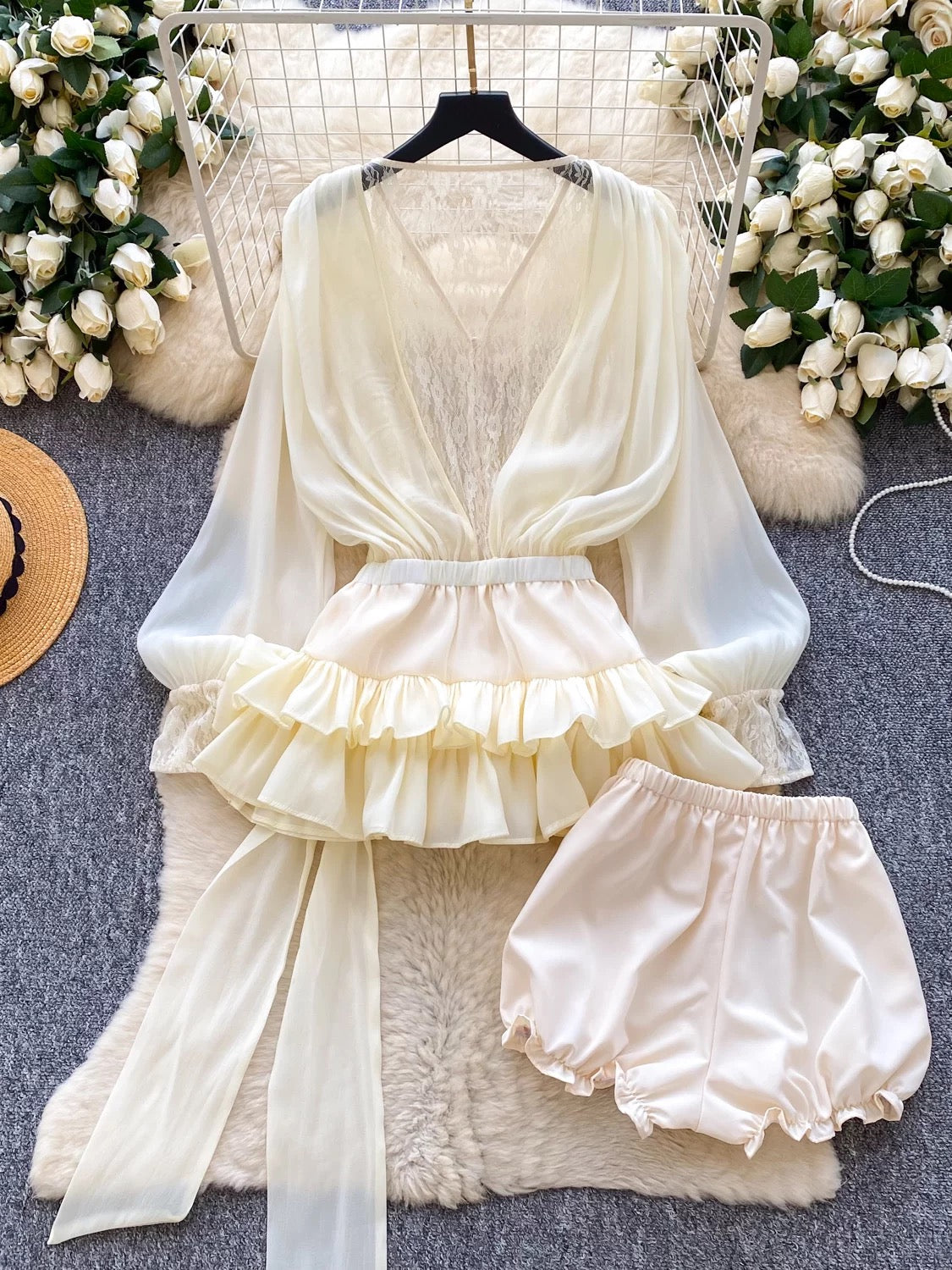 A fairy-tale style, unique design featuring a bow tie, cinched waist, lace trim, long sleeves, ruffles, and mesh. Shorts are also available.