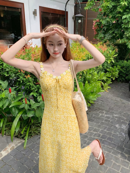 Zeng Xiaoxian yellow floral-print camisole maxi dress featuring a waist-cinching fit, 3D floral embellishments, and a vacation-ready, atmospheric style.