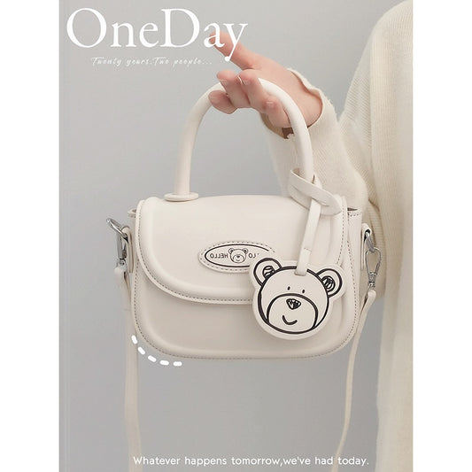 Bag women 2022 new style gentle wind bear decoration age-reducing girl crossbody bag all-match texture one-shoulder saddle bag